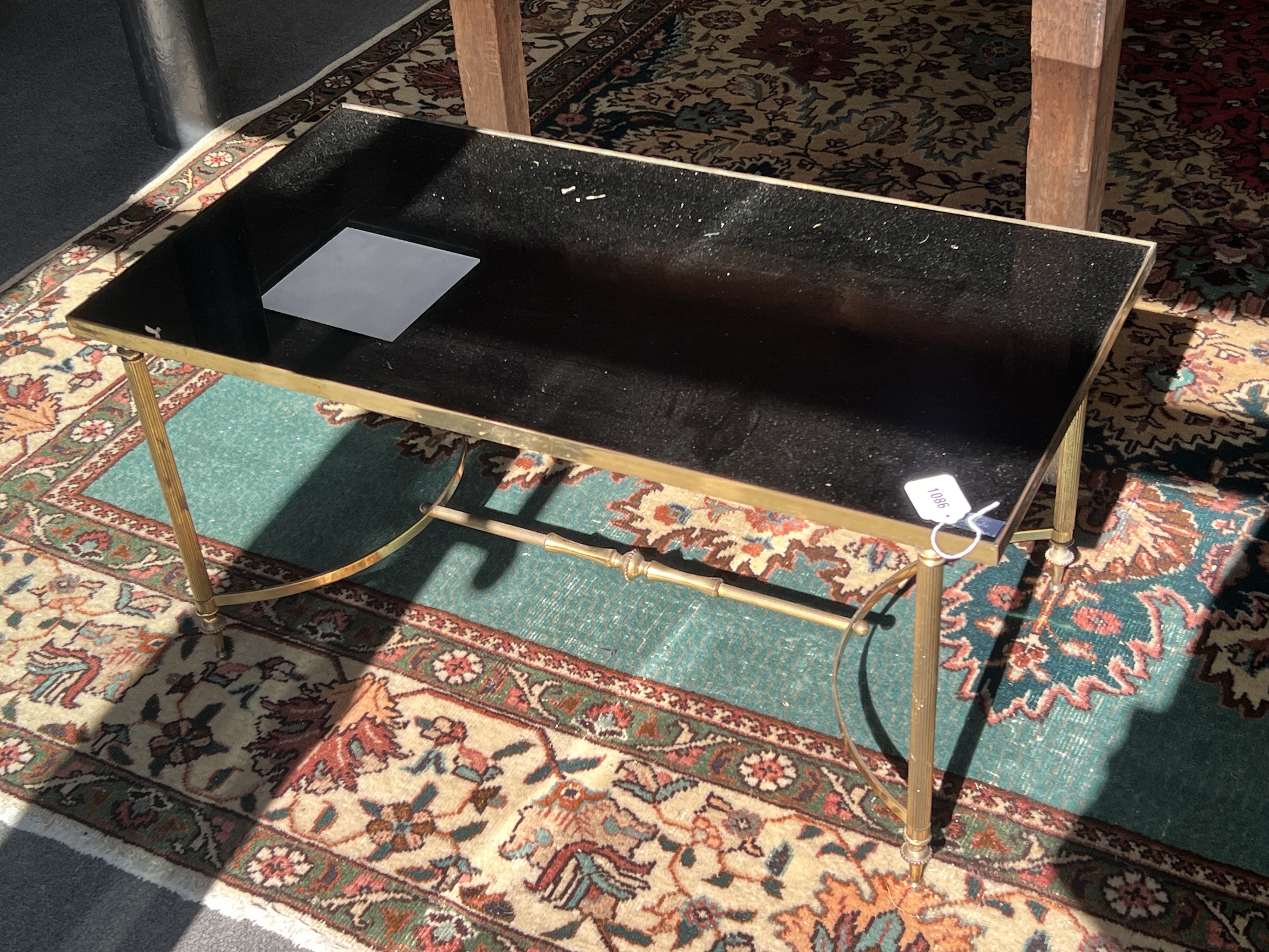 A Maison Jansen style brass and black glass coffee table, width 87cm, depth 45cm, height 41cm